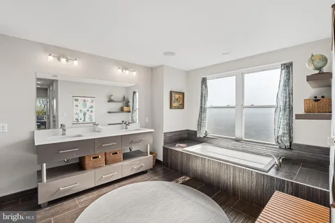 a living room with stainless steel appliances kitchen island granite countertop furniture and a large window