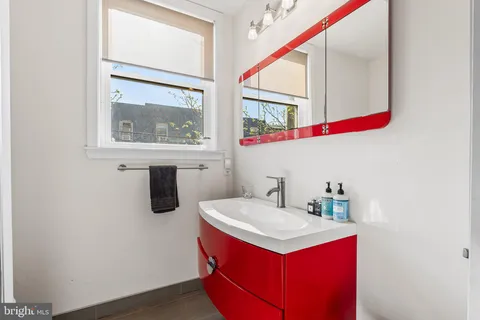 a bathroom with a sink vanity and a mirror