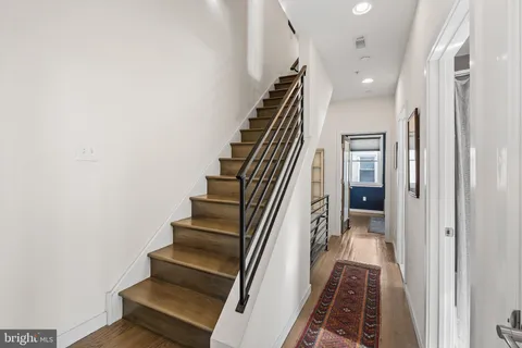 a view of a hallway with wooden floor and entryway