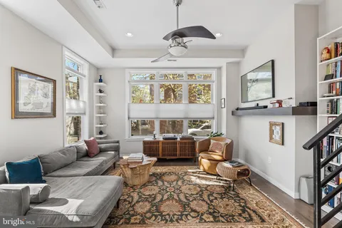 a living room with furniture and a large window