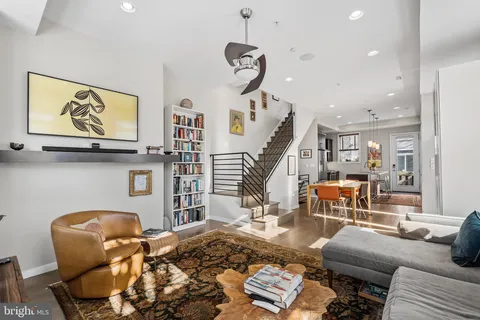 a living room with furniture and wooden floor