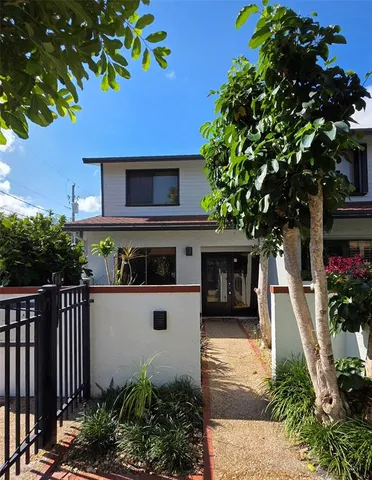 a front view of a house with a garden