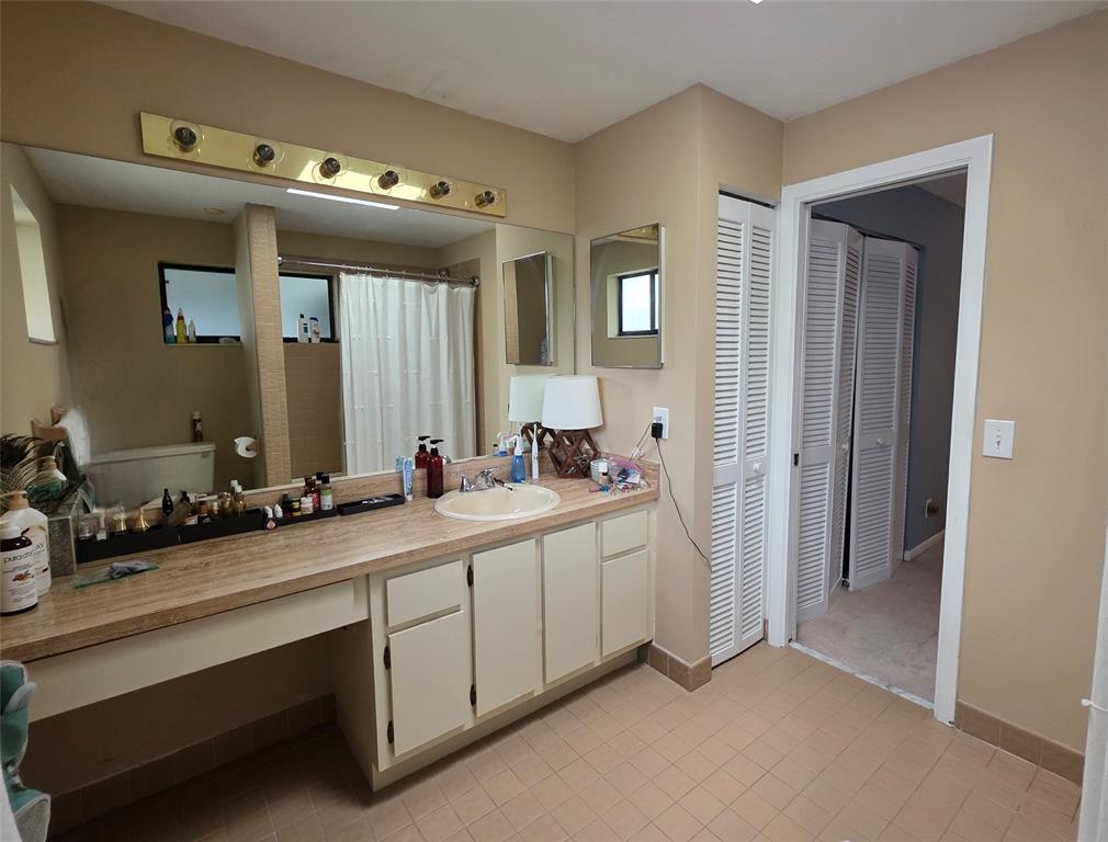 817 Southeast 12th Court, Unit 1 Fort Lauderdale, FL 33316 - Photo 12 of 25 a bathroom with a double vanity sink and mirror