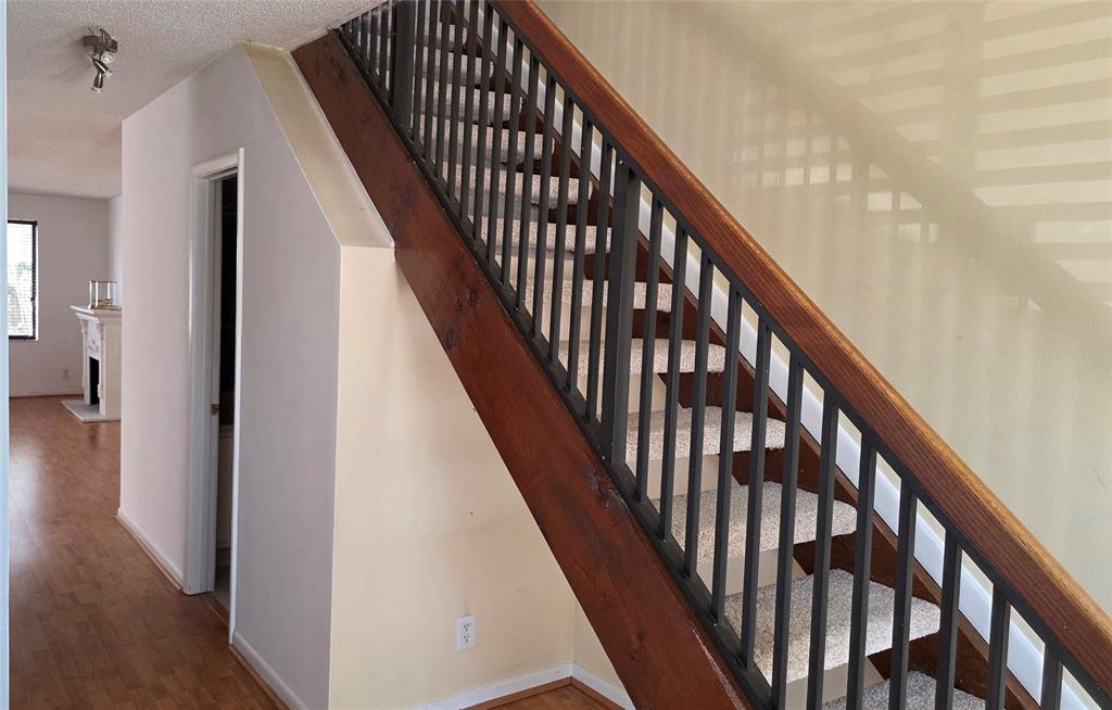 817 Southeast 12th Court, Unit 1 Fort Lauderdale, FL 33316 - Photo 16 of 25 a view of staircase with lots of frames on wall and wooden floor