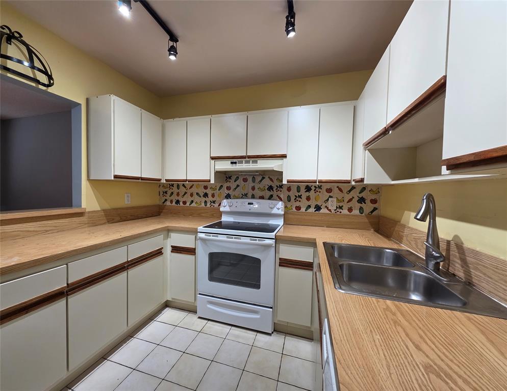 817 Southeast 12th Court, Unit 1 Fort Lauderdale, FL 33316 - Photo 9 of 25 a kitchen with a sink stove top oven and cabinets