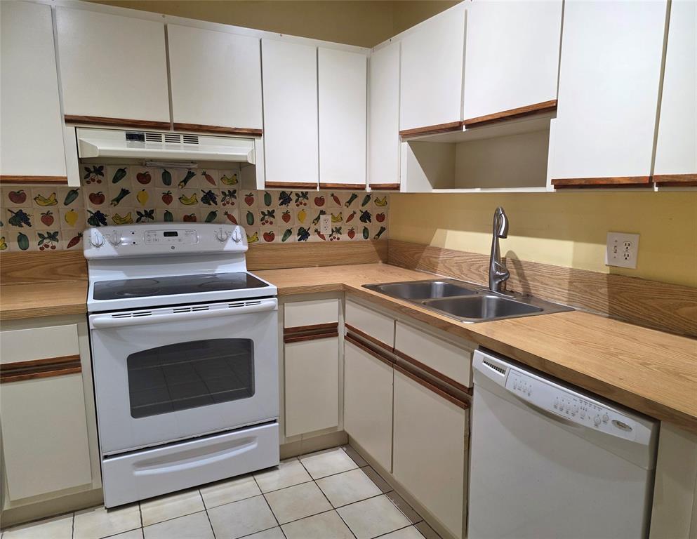 817 Southeast 12th Court, Unit 1 Fort Lauderdale, FL 33316 - Photo 10 of 25 a kitchen with granite countertop a stove sink and cabinets