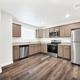 a kitchen with a refrigerator a stove top oven a sink and dishwasher