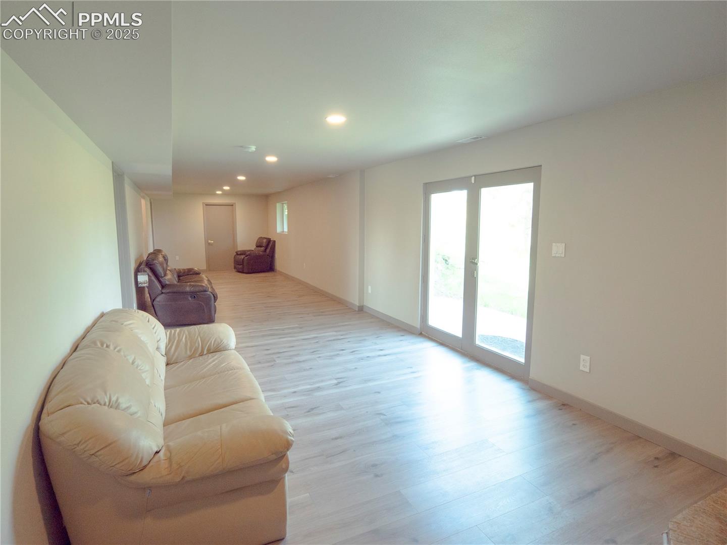 4130 Walker Road Colorado Springs, CO 80908 - Photo 32 of 39 Living room featuring light wood-style floors and recessed lighting