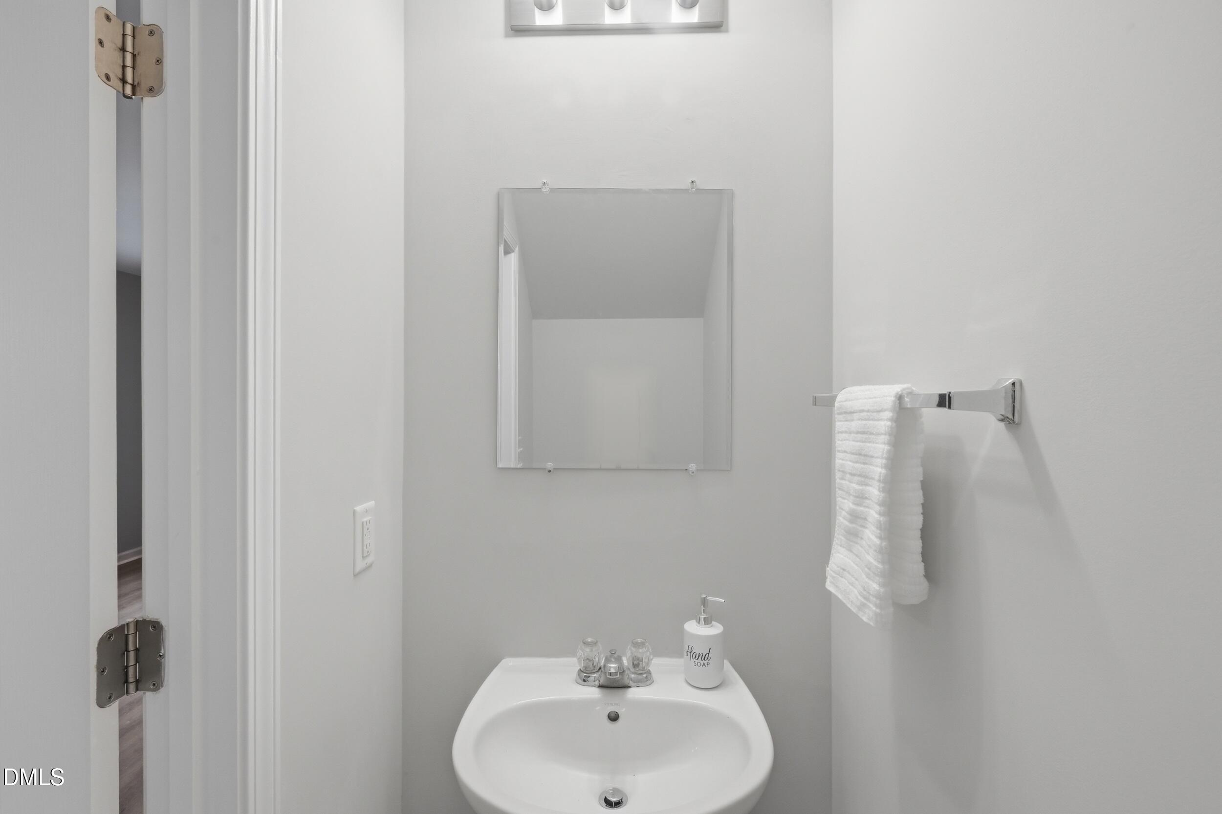2907 Berkeley Springs Place Raleigh, NC 27616 - Photo 26 of 34 a bathroom with a sink and mirror