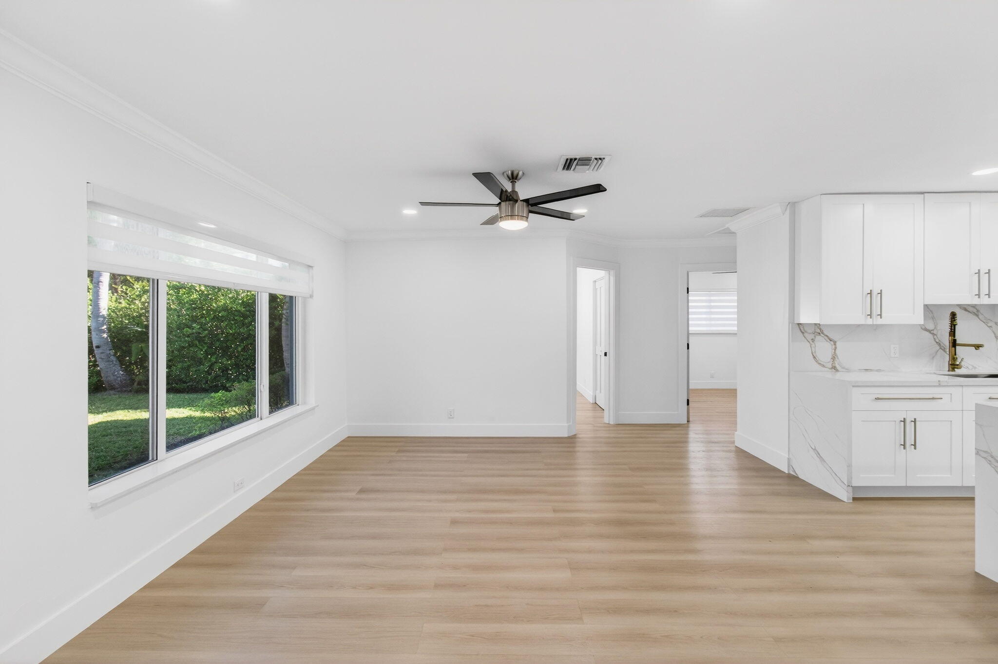 360 Southwest 2nd Street Boca Raton, FL 33432 - Photo 15 of 100 a view of an empty room with a window and wooden floor