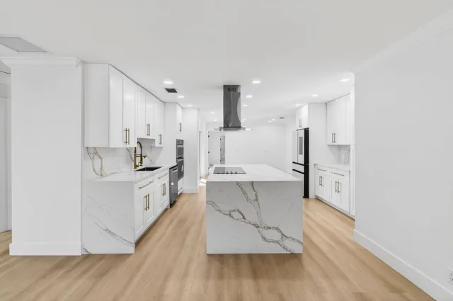 a bathroom with a granite countertop sink a toilet and shower