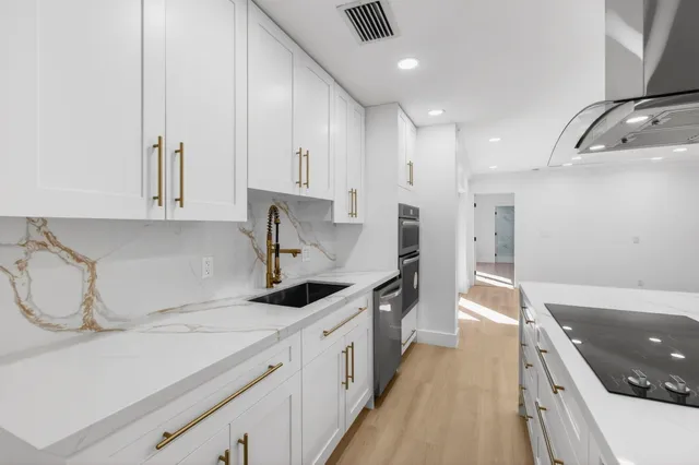 a view of a big room with wooden floor and windows