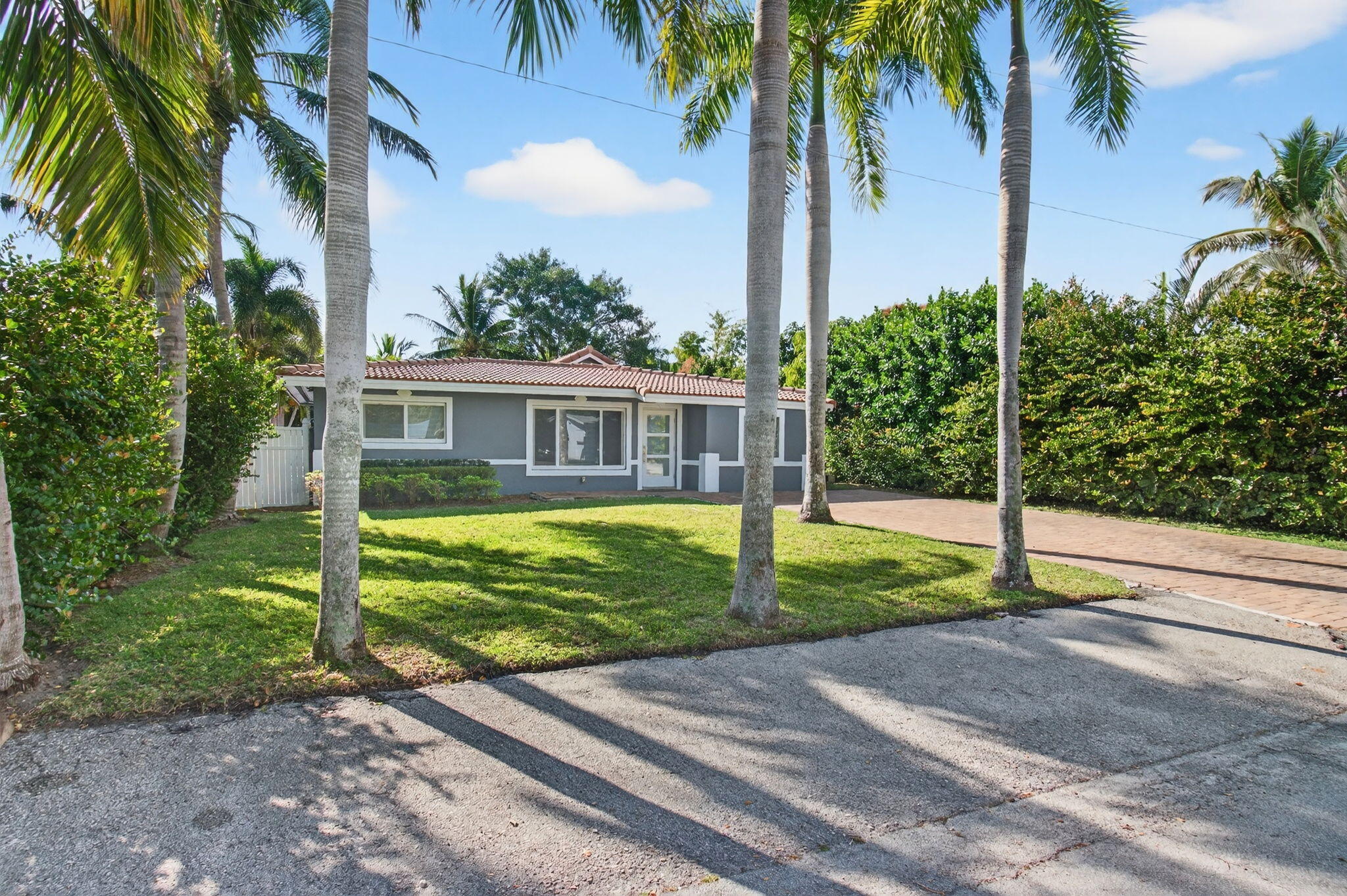 360 Southwest 2nd Street Boca Raton, FL 33432 - Photo 2 of 100 a view of a house with a yard and palm trees