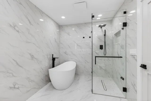 an aerial view of residential house with outdoor space and trees all around