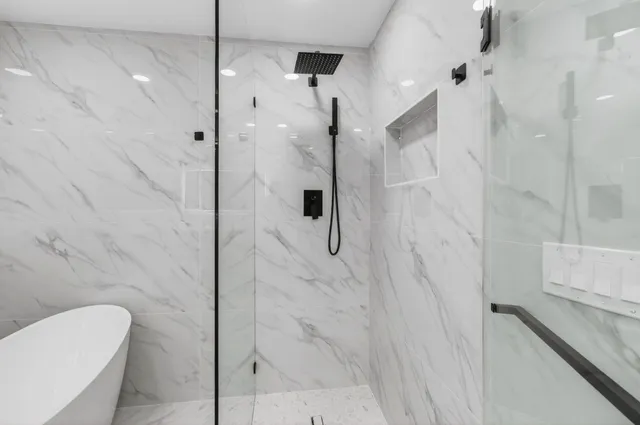 an aerial view of residential houses with outdoor space and trees