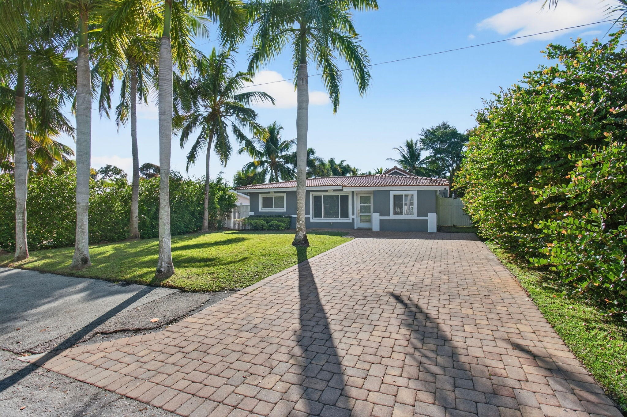 360 Southwest 2nd Street Boca Raton, FL 33432 - Photo 4 of 100 a view of a house with a yard and palm trees