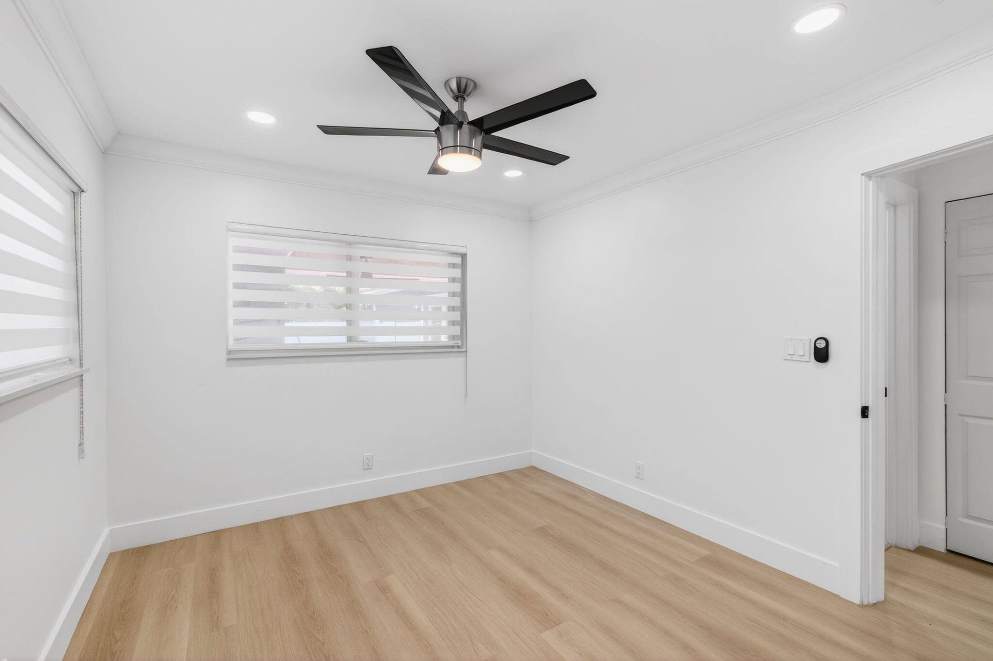 360 Southwest 2nd Street Boca Raton, FL 33432 - Photo 55 of 100 an empty room with wooden floor ceiling fan and windows