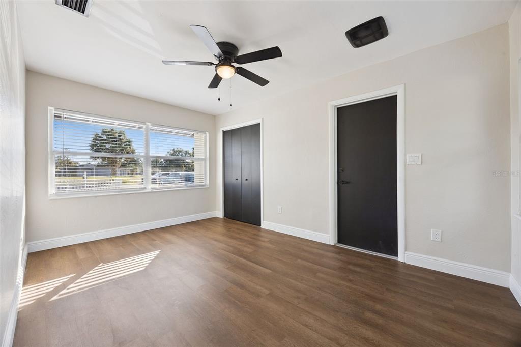 1001 Alton Avenue Orlando, FL 32804 - Photo 11 of 20 a view of an empty room with wooden floor and a window