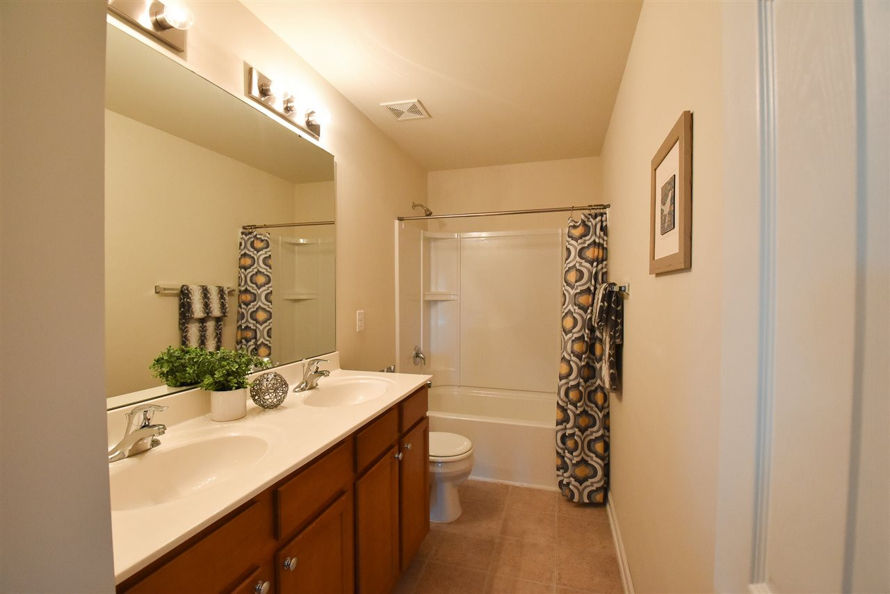 4201 Kellett Lane Raleigh, NC 27616 - Photo 23 of 30 The add'l Bedrooms share the lg Hall Bath w/double sinks, neutral vinyl floor & tub-shower. Hall Bath