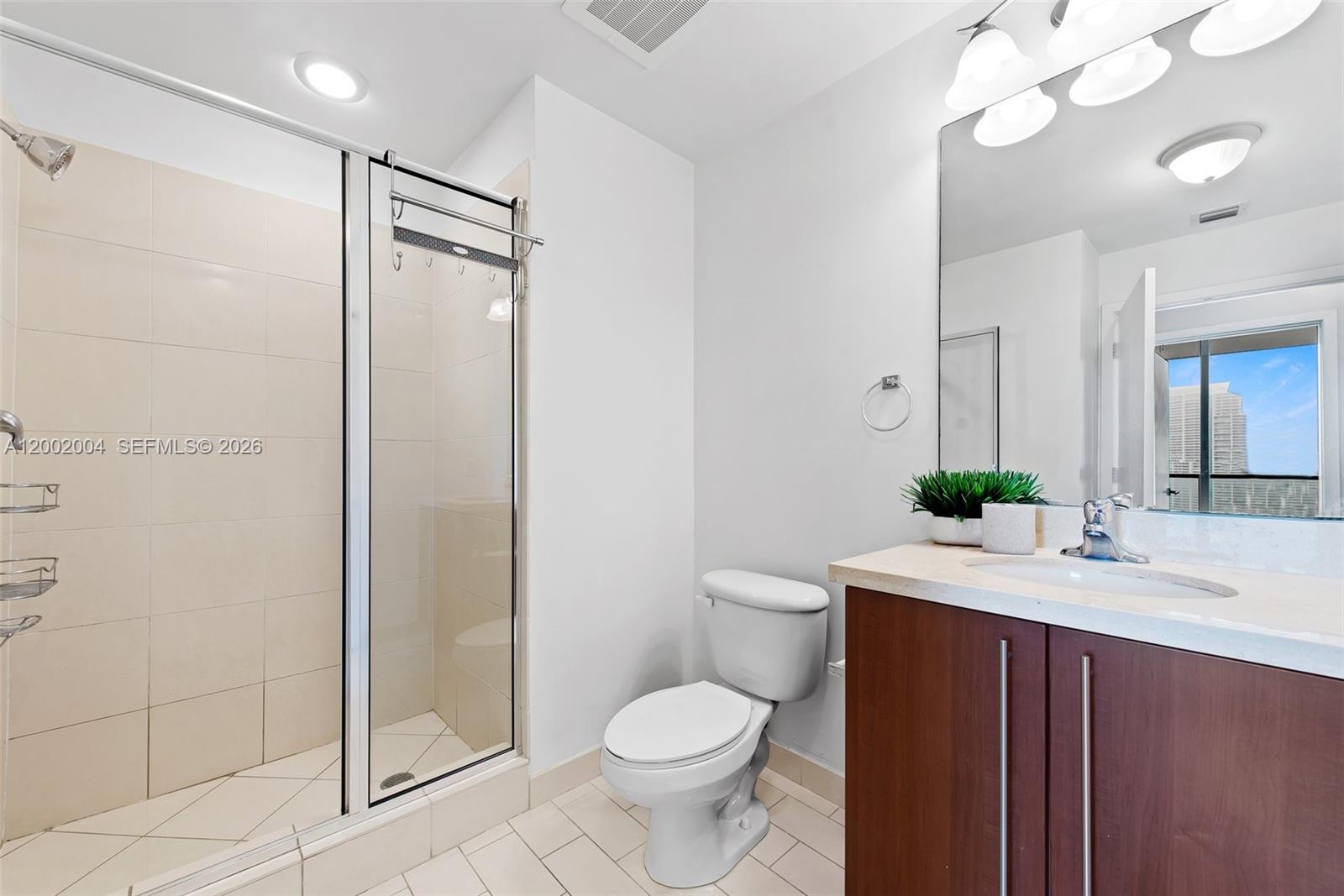 79 Southwest 12th Street, Unit 2503S Miami, FL 33130 - Photo 17 of 27 a bathroom with a sink toilet and shower