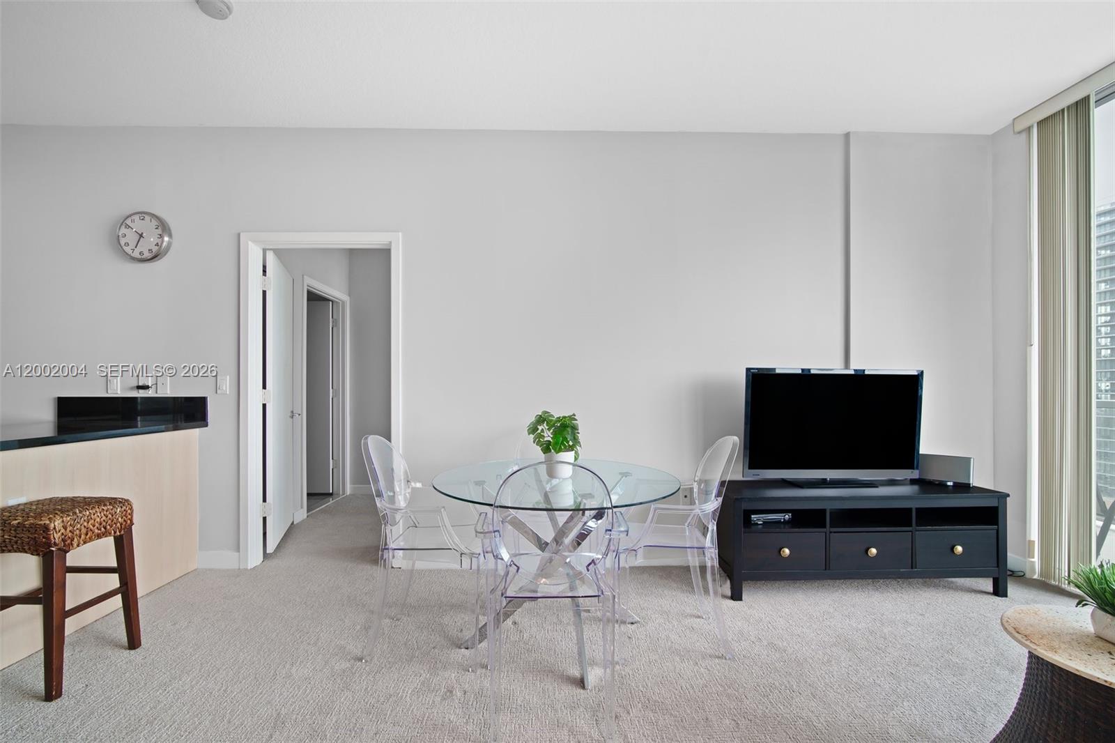 79 Southwest 12th Street, Unit 2503S Miami, FL 33130 - Photo 4 of 27 a living room with furniture and a flat screen tv