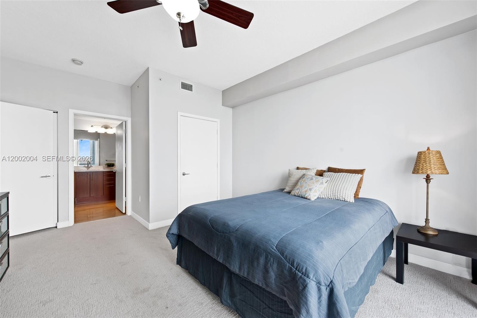 79 Southwest 12th Street, Unit 2503S Miami, FL 33130 - Photo 9 of 27 a bedroom with a bed and a chandelier