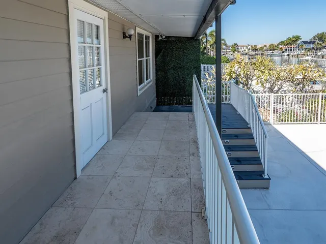 a view of a house with swimming pool and sitting area