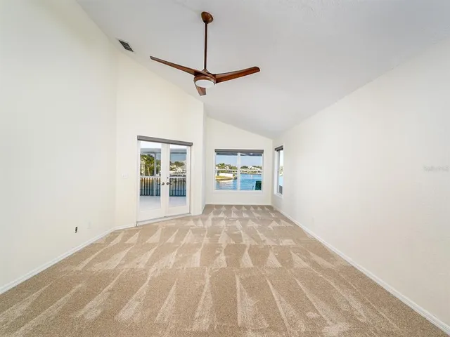 a view of a lake with boats and trees in the background
