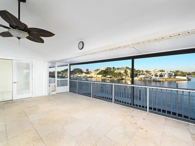 an aerial view of a city with lots of residential buildings ocean and mountain view in back