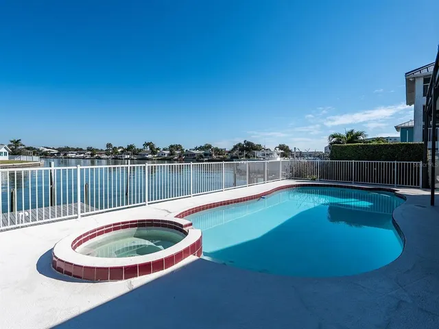 an aerial view of residential houses with outdoor space and lake view