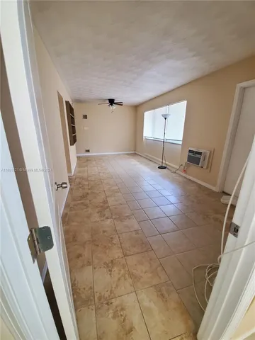 a view of a livingroom with wooden floor and stairs