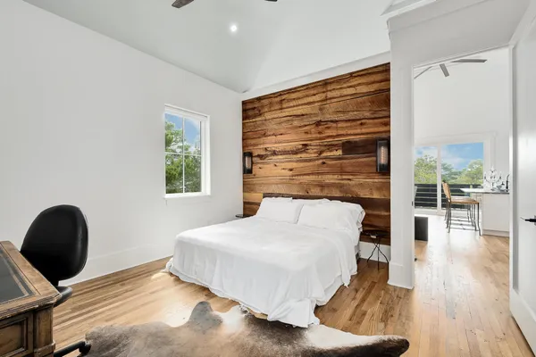 a bedroom with a bed and a flat screen tv