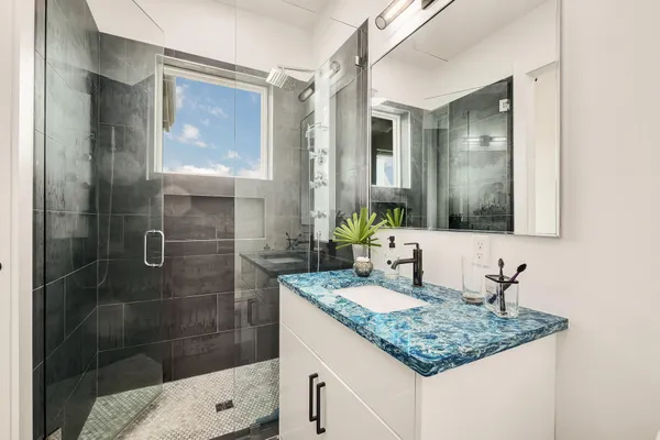 a kitchen with granite countertop a sink stove and cabinets