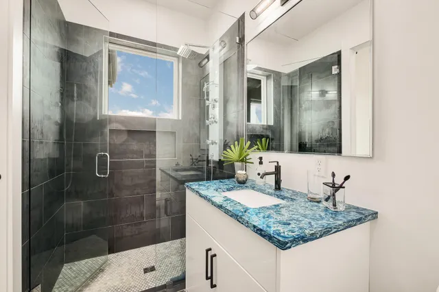 a kitchen with granite countertop a sink stove and cabinets
