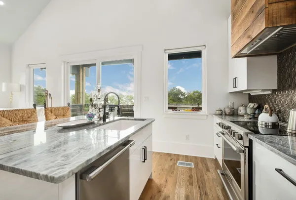 a kitchen with stainless steel appliances kitchen island granite countertop a sink and cabinets