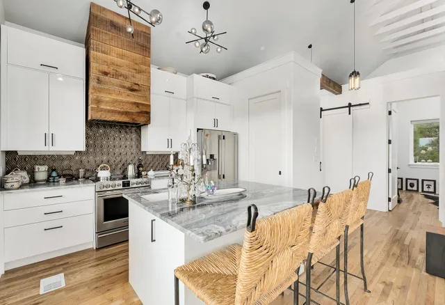 a kitchen with stainless steel appliances granite countertop a sink and cabinets