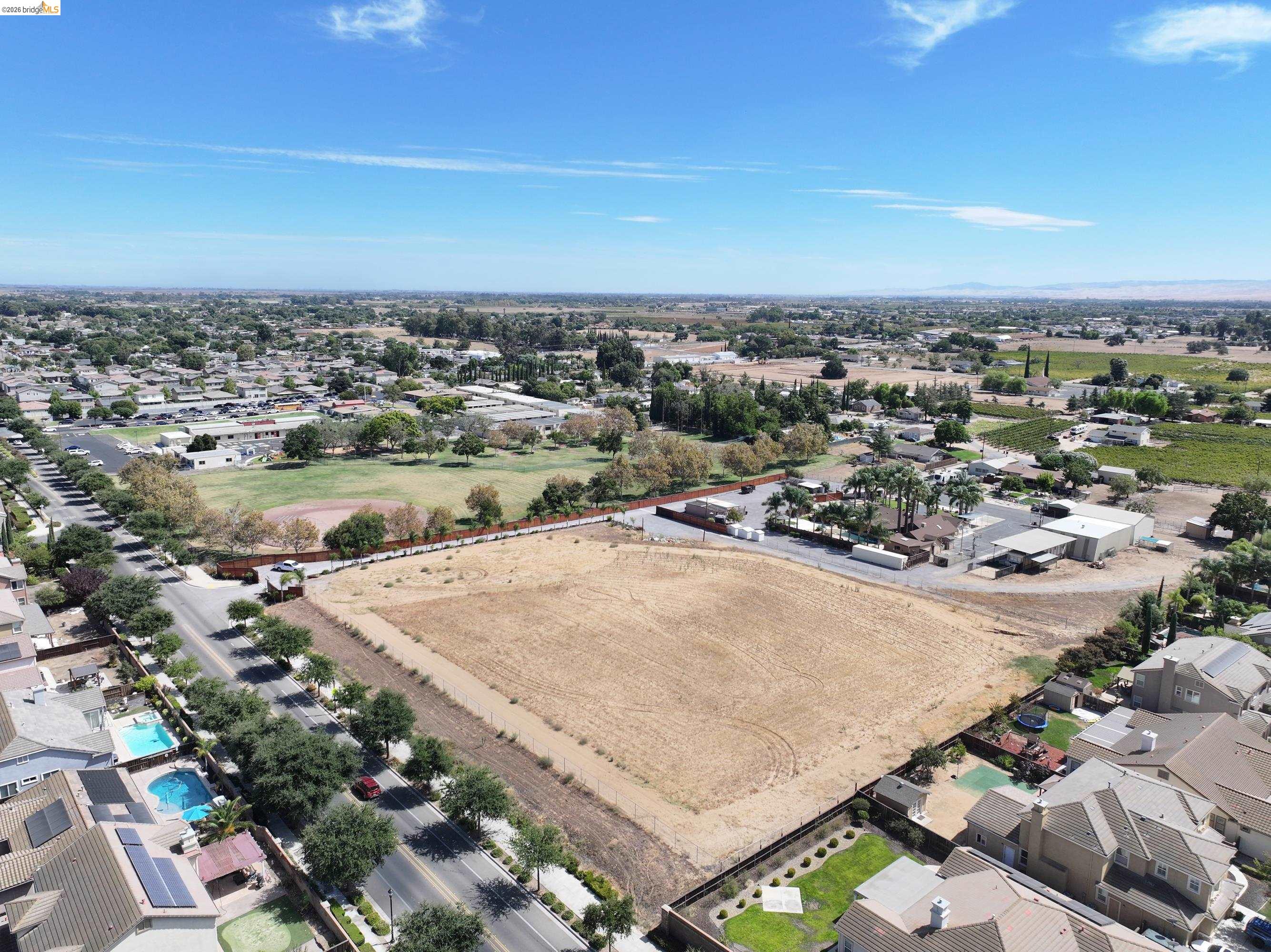 340 West Bolton Road Oakley, CA 94561 - Photo 87 of 87 Expansive undeveloped lot with surrounding residential properties, adjacent to a public park with a baseball field