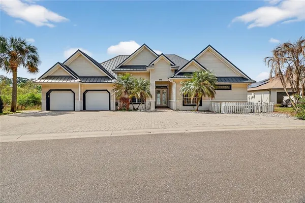 an aerial view of a house with a yard and lake view