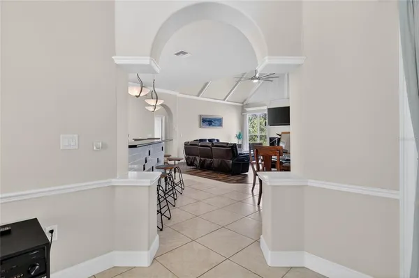 a kitchen with stainless steel appliances a refrigerator sink stove and white cabinets
