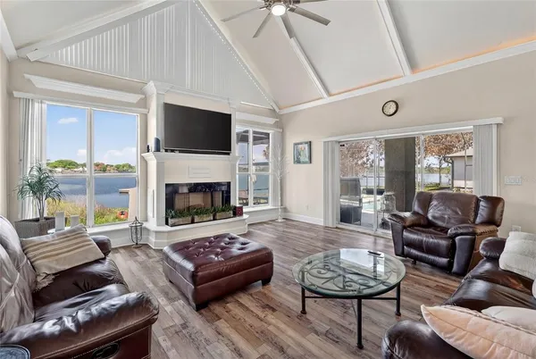 a view of a hallway with wooden floor and a bathroom