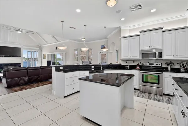 a view of a dining room with furniture a livingroom and chandelier