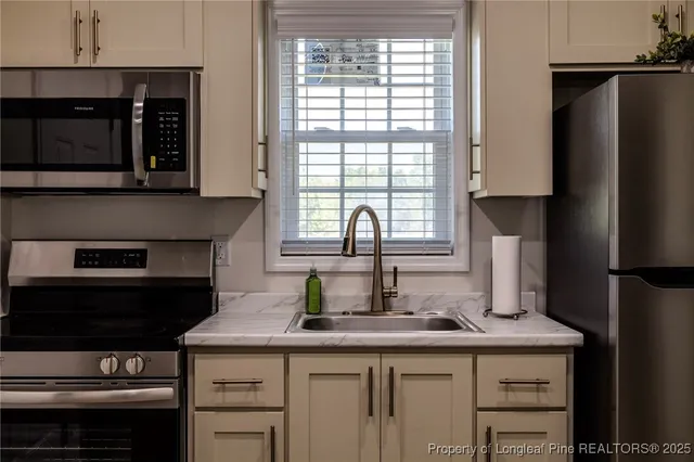 a kitchen with a sink and a refrigerator