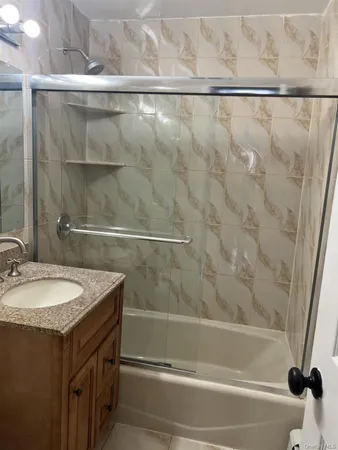 a bathroom with a shower and a sink