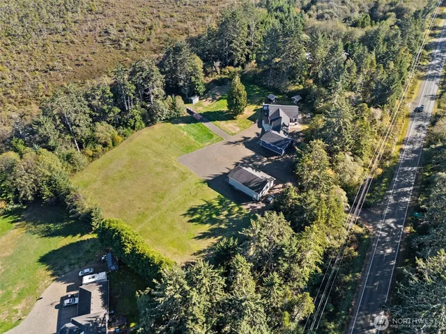 an aerial view of a house with a yard