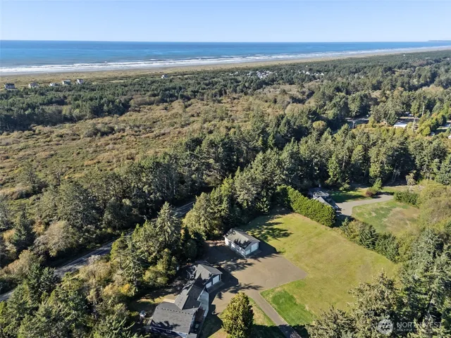 an aerial view of a houses with a yard