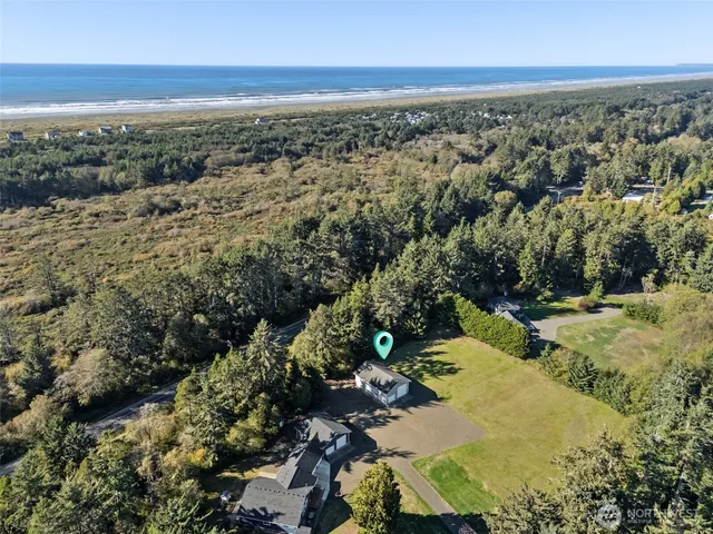 an aerial view of a houses with a yard