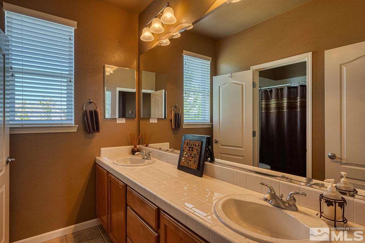 490 Oldenburg Drive Reno, NV 89521 - Photo 18 of 25 a bathroom with a double vanity sink and a mirror