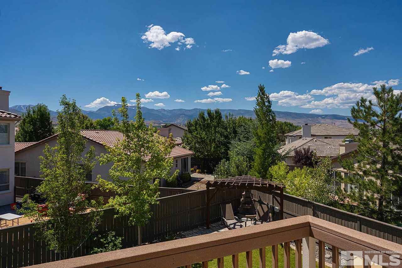 490 Oldenburg Drive Reno, NV 89521 - Photo 21 of 25 a view of a balcony with dining table and chairs with an outdoor space