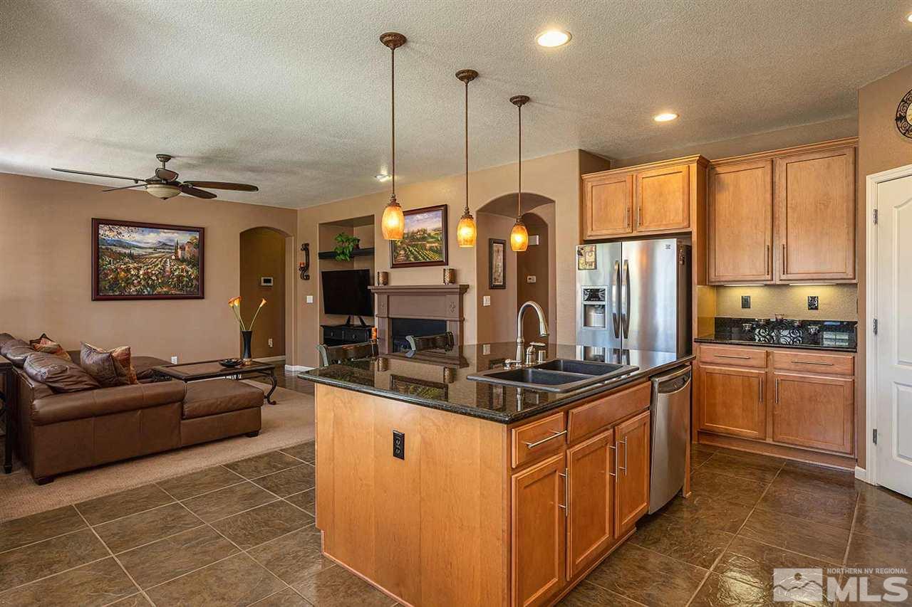 490 Oldenburg Drive Reno, NV 89521 - Photo 6 of 25 a kitchen with stainless steel appliances granite countertop a stove a sink and a refrigerator