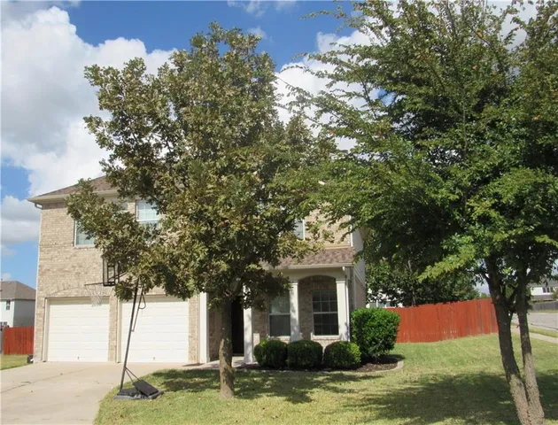 a front view of a house with a yard garage and outdoor seating